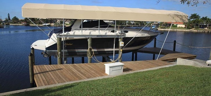 Boat on lift at waterfront dock